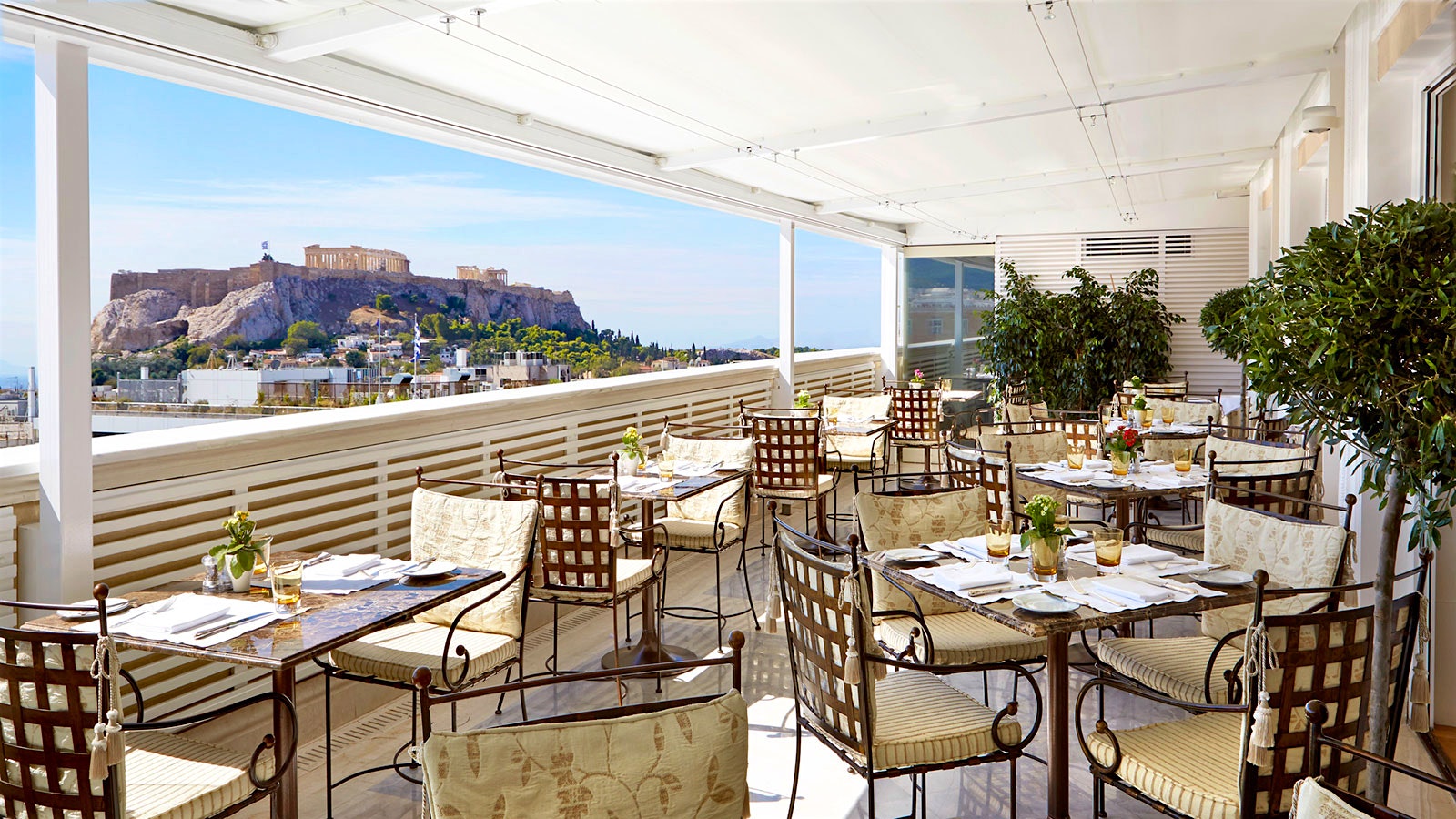 Outdoor tables at Tudor Hall Restaurant, with a view of the Acropolis of Athens